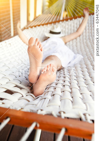Woman lying in hammock 63447048
