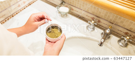Female hands are taking eye patches out from the Female hands are taking eye patches out from the 63447127