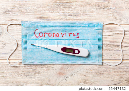 Pile of protective medical masks with coronavirus 63447182