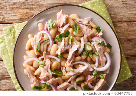 tuna and white bean salad close-up in a plate. 63447793