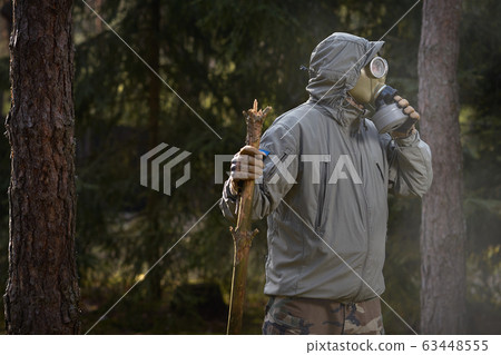 man in a gas mask protects himself from coronavirus man in a gas mask protects himself from coronavirus 63448555