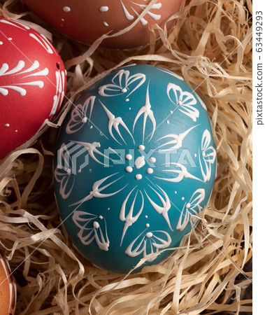Detail of blue Easter egg decorated with wax 63449293