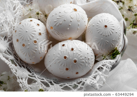 Detail of blown out white Easter eggs decorated 63449294