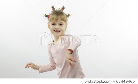 Positive girl in pink blouse dancing. Happy four little child. White background Positive girl in pink blouse dancing. Happy four little child. White background 63449460