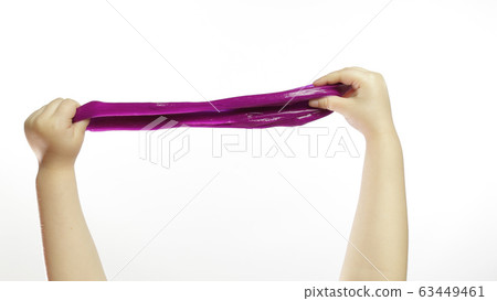 Child hands playing oddly purple slime on white background. Antistress Child hands playing oddly purple slime on white background. Antistress 63449461