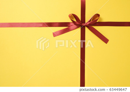 Red ribbon bow tied on yellow background 02 Red ribbon bow tied on yellow background 02 63449647