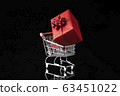 Shopping trolley cart and gift box on black background. Buying presents concept, online shopping. 63451022