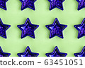 Seamless pattern from five pointed violet metallic star on pastel green surface 63451051