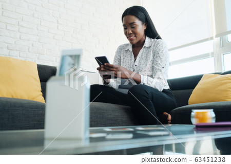 Black Woman Using Portable Wi-Fi Printer For Printing Pictures 63451238