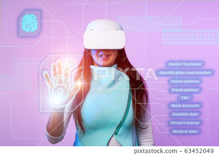 Woman is using vr headset to access for personal data. Woman is using vr headset to access for personal data. 63452049