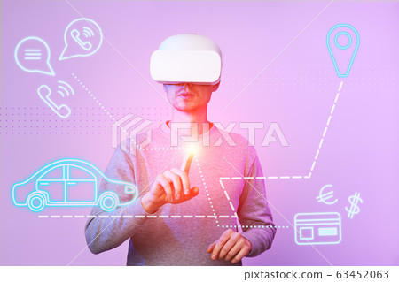 Man calls taxi using virtual reality headset. 63452063