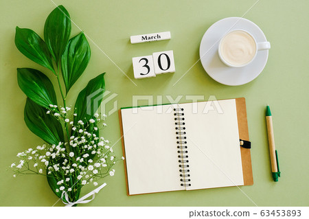 Wooden cubes calendar March 30. Notepad, cup of 63453893