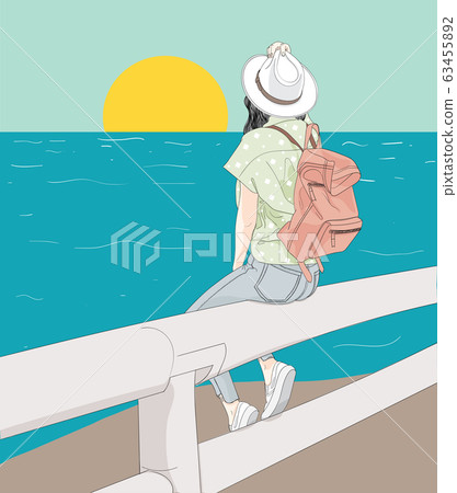 Woman sitting on the beach, looking at the sun 63455892