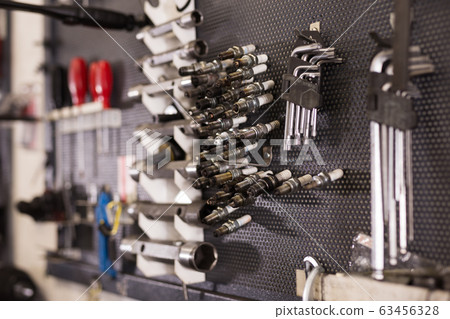 Empty workshop for motorbike repair with table with different tools 63456328