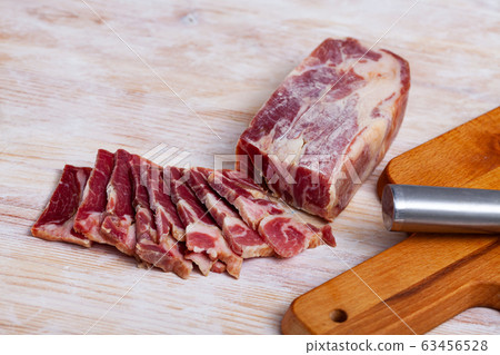 Dry-cured pork neck with cut pieces 63456528