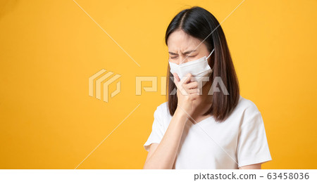 Asian women wear masks to protect disease on orange background. 63458036