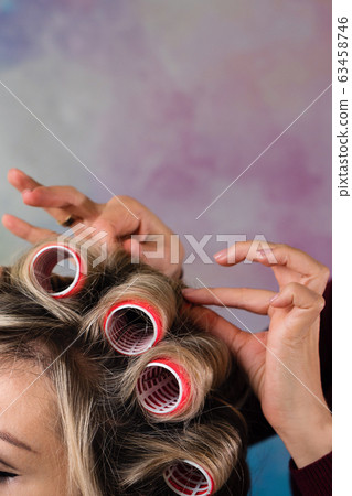 Creating stylish look of housewife in curlers Creating stylish look of housewife in curlers 63458746