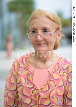 Beautiful senior tourist woman with blond hair relaxing around t Beautiful senior tourist woman with blond hair relaxing around t 63458979