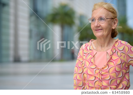 Beautiful senior tourist woman with blond hair relaxing around t Beautiful senior tourist woman with blond hair relaxing around t 63458980