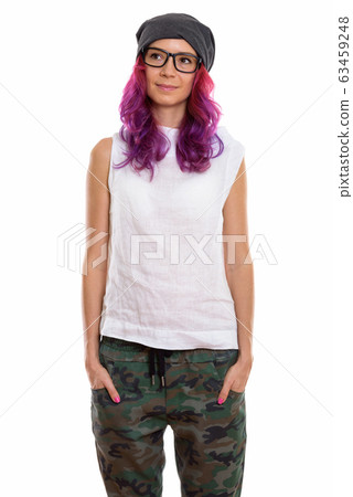 Studio shot of young beautiful woman standing and thinking with 63459248