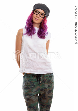 Studio shot of young beautiful woman standing and thinking while Studio shot of young beautiful woman standing and thinking while 63459249