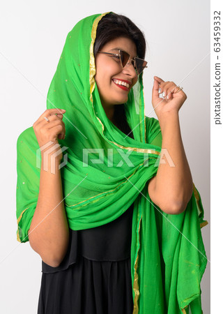 Happy young Persian woman with sunglasses smiling in traditional clothing Happy young Persian woman with sunglasses smiling in traditional clothing 63459332