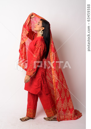 Full body shot profile view of young Persian woman in traditional clothing Full body shot profile view of young Persian woman in traditional clothing 63459388