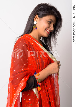 Profile view of happy young Persian woman smiling in traditional clothing 63459968