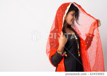 Profile view of happy young Persian woman smiling in traditional clothing Profile view of happy young Persian woman smiling in traditional clothing 63459983