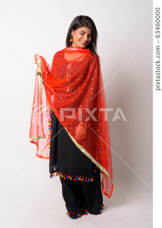 Full body shot of happy young Persian woman smiling in traditional clothing Full body shot of happy young Persian woman smiling in traditional clothing 63460000