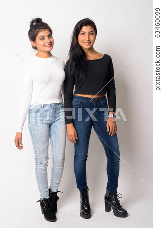 Full body shot of two happy young Persian women smiling together Full body shot of two happy young Persian women smiling together 63460099