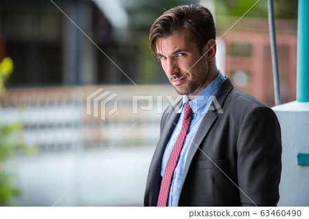 Young handsome Hispanic businessman wearing suit outdoors Young handsome Hispanic businessman wearing suit outdoors 63460490