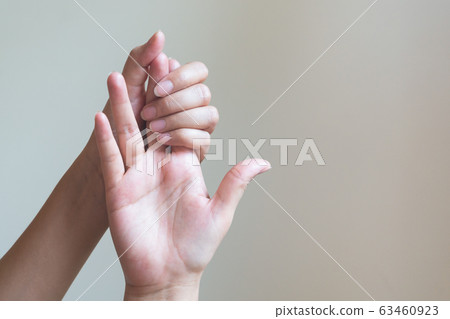 Woman massaging her painful hand. Healthcare and medical concept. 63460923