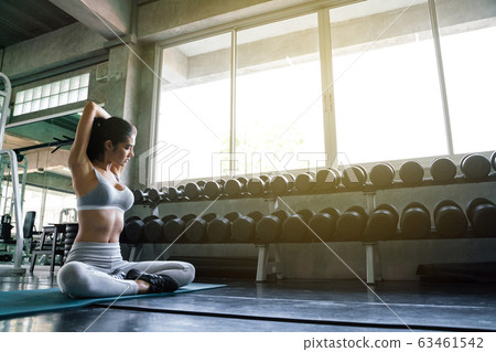 Sporty sexy women doing stretching at gym Sporty sexy women doing stretching at gym 63461542