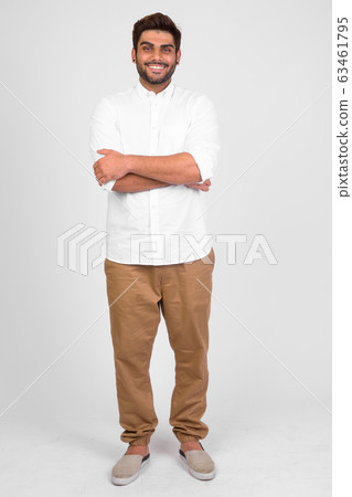 Full body shot of happy young bearded Indian man with arms crossed Full body shot of happy young bearded Indian man with arms crossed 63461795