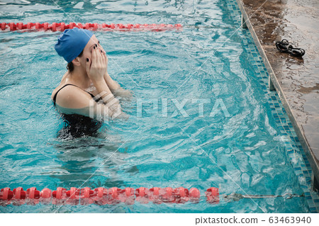 Rubbing eyes in swimming pool Rubbing eyes in swimming pool 63463940