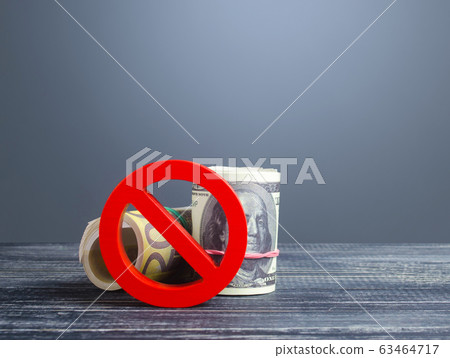 Rolls of money dollar euro blocked by red prohibition symbol NO. Capital outflow restrictions. Sanctions. Regulatory laws in financial sector. Diversification foreign currencies exchange reserves. Rolls of money dollar euro blocked by red prohibition symbol NO. Capital outflow restrictions. Sanctions. Regulatory laws in financial sector. Diversification foreign currencies exchange reserves. 63464717
