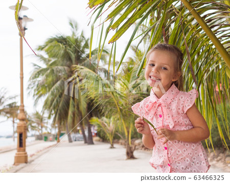 beautiful baby girl in the pink shirt is staying 63466325