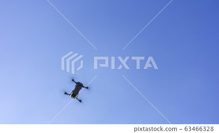 Drone floating in the blue sky Drone floating in the blue sky 63466328