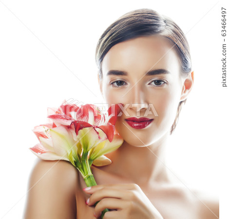 young pretty brunette woman with red flower amaryllis close up isolated on white background. Fancy fashion makeup, bright lipstick, creative Ombre manicured nails. spa skin care young pretty brunette woman with red flower amaryllis close up isolated on white background. Fancy fashion makeup, bright lipstick, creative Ombre manicured nails. spa skin care 63466497