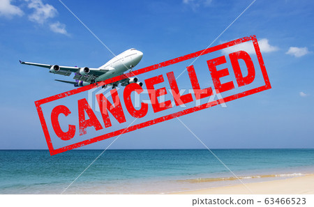 flight cancellation. commercial airplane flight over the sea with red stamp text trip cancelled from city shutdown and border closed, effect from COVID-19 Coronavirus outbreak situation 63466523