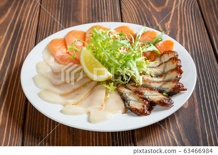 Mixed fish plate on wooden table. Cold starter. Mixed fish plate on wooden table. Cold starter. 63466984