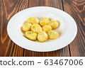 Plate of boiled potatos on wooden table 63467006