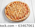 Fresh italian pizza with chicken on wooden table 63467061