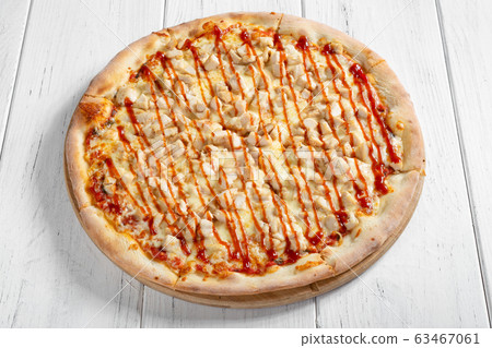 Fresh italian pizza with chicken on wooden table Fresh italian pizza with chicken on wooden table 63467061