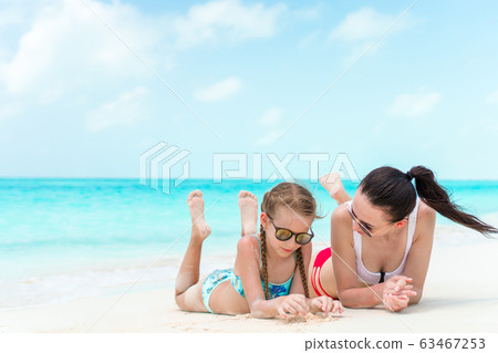 Beautiful mother and daughter on the beach 63467253