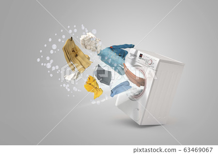Washing machine and flying clothes on grey 63469067