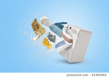 Washing machine and flying clothes on blue 63469068