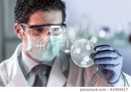 Scientist working in corona virus vaccine development laboratory research facility. 63469917