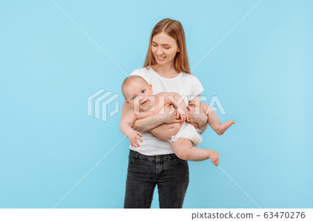 Happy cheerful mom playing with her little baby on Happy cheerful mom playing with her little baby on 63470276